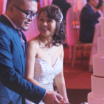 An image of a couple cutting their cake during their wedding reception; Toronto Wedding Video blog